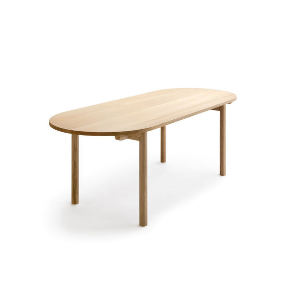 A rectangular dining table with rounded edges, creating a pleasing oblong oval shape
