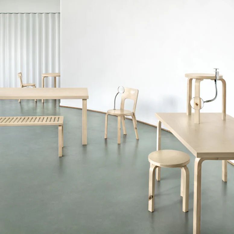 White slatted bench with metal legs, modern minimalist style.