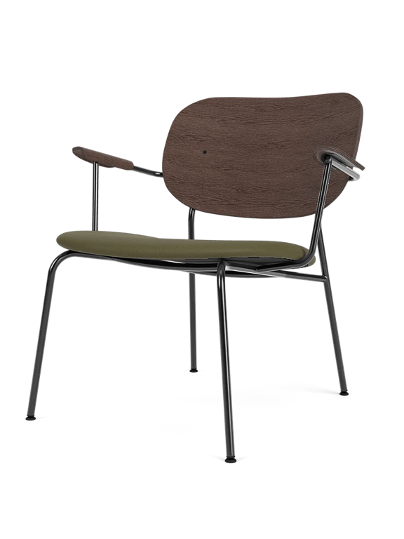 Side view of a chair with beige upholstery and metal frame in a modern setting