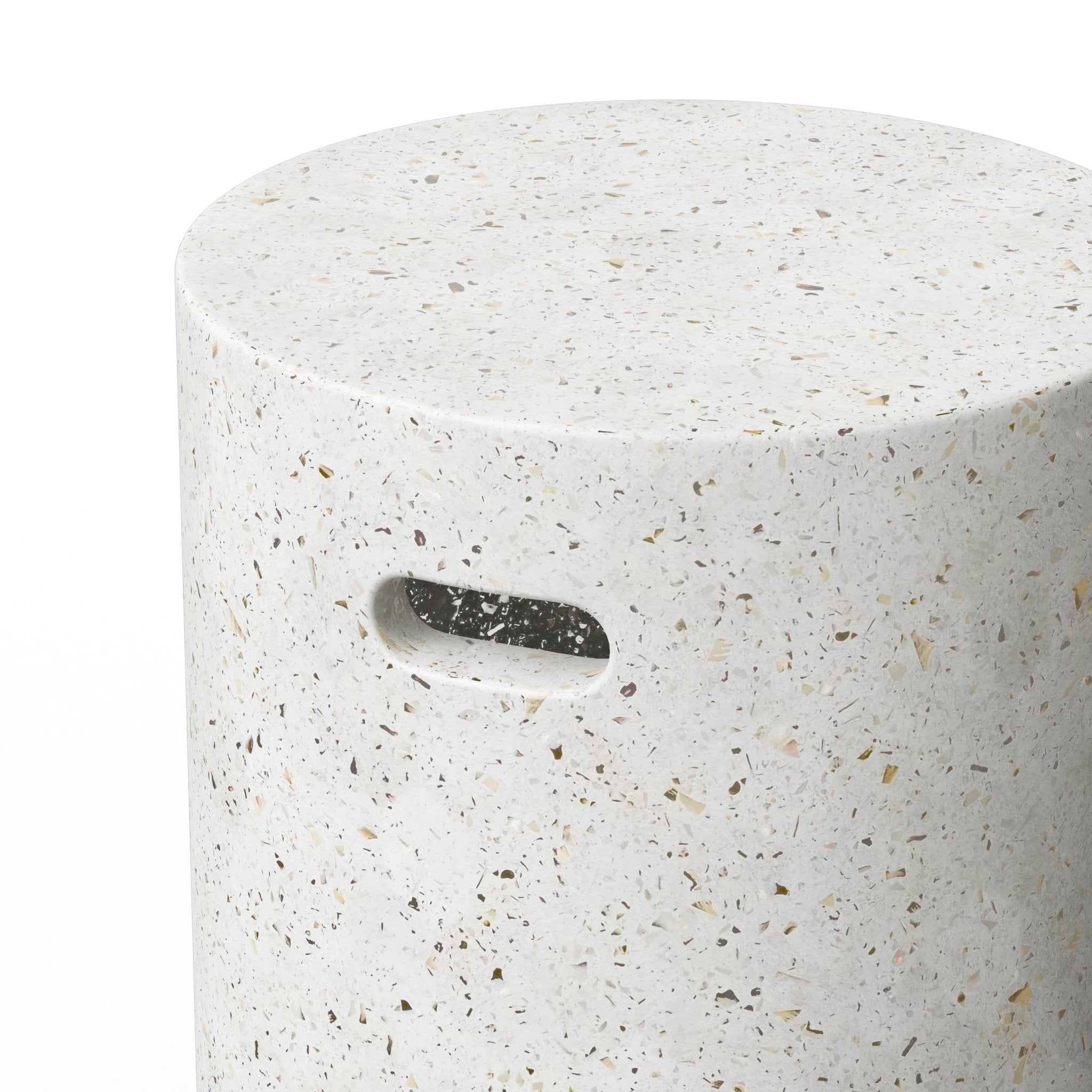 Close-up of a dark brown cylindrical stool with a small oval handle cutout, focusing on the top and side.
