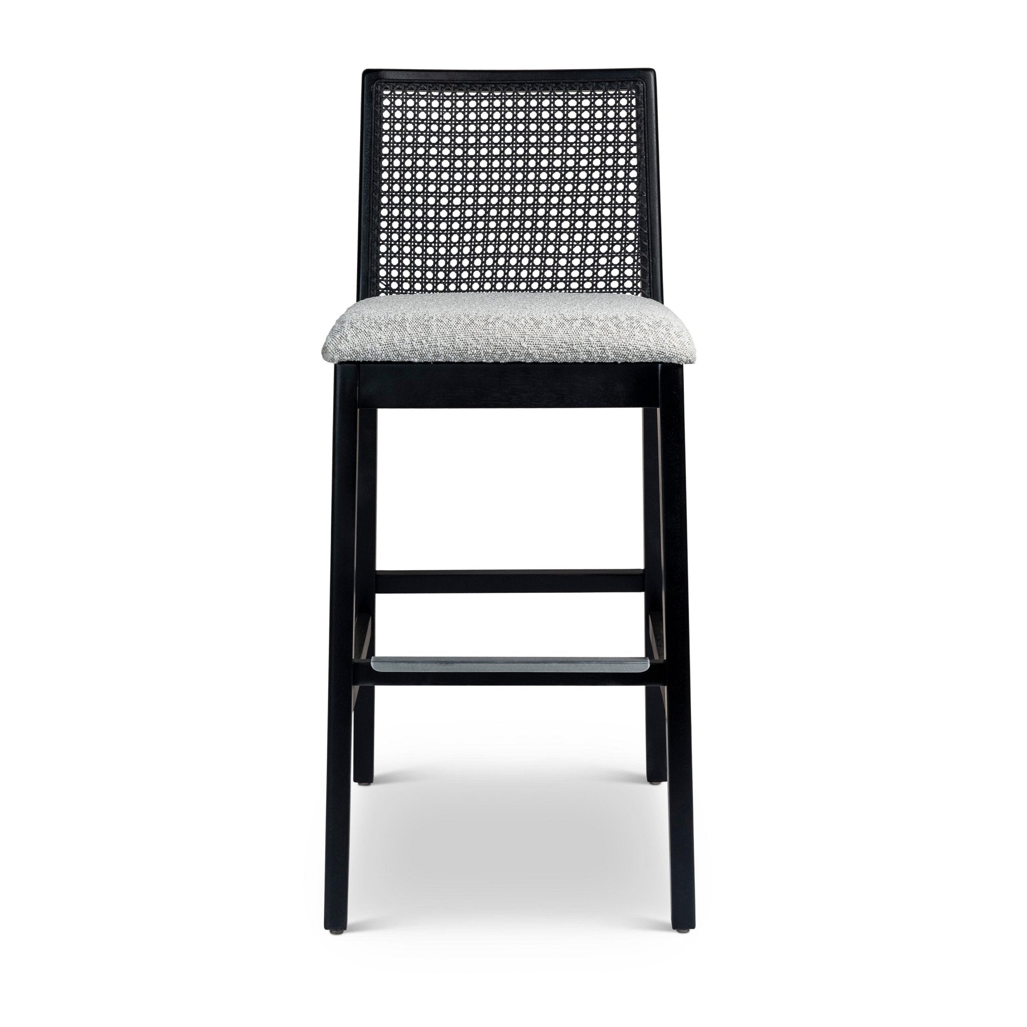 Light wood bar stool with caned back and light grey upholstered seat.