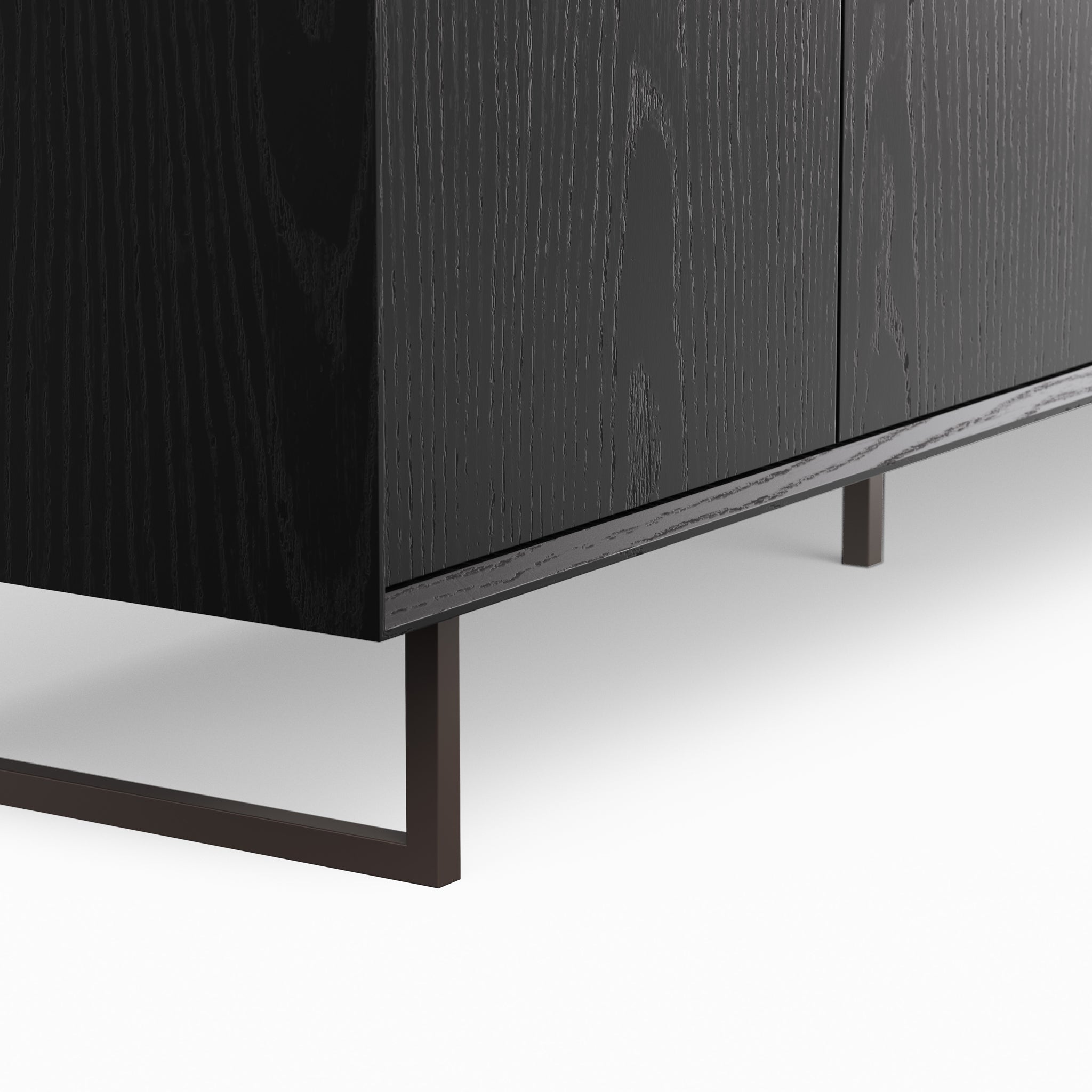Close-up of black wood cabinet side with visible wood grain and leg.