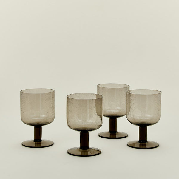 Set of four simple seeded stemware in smoke.
