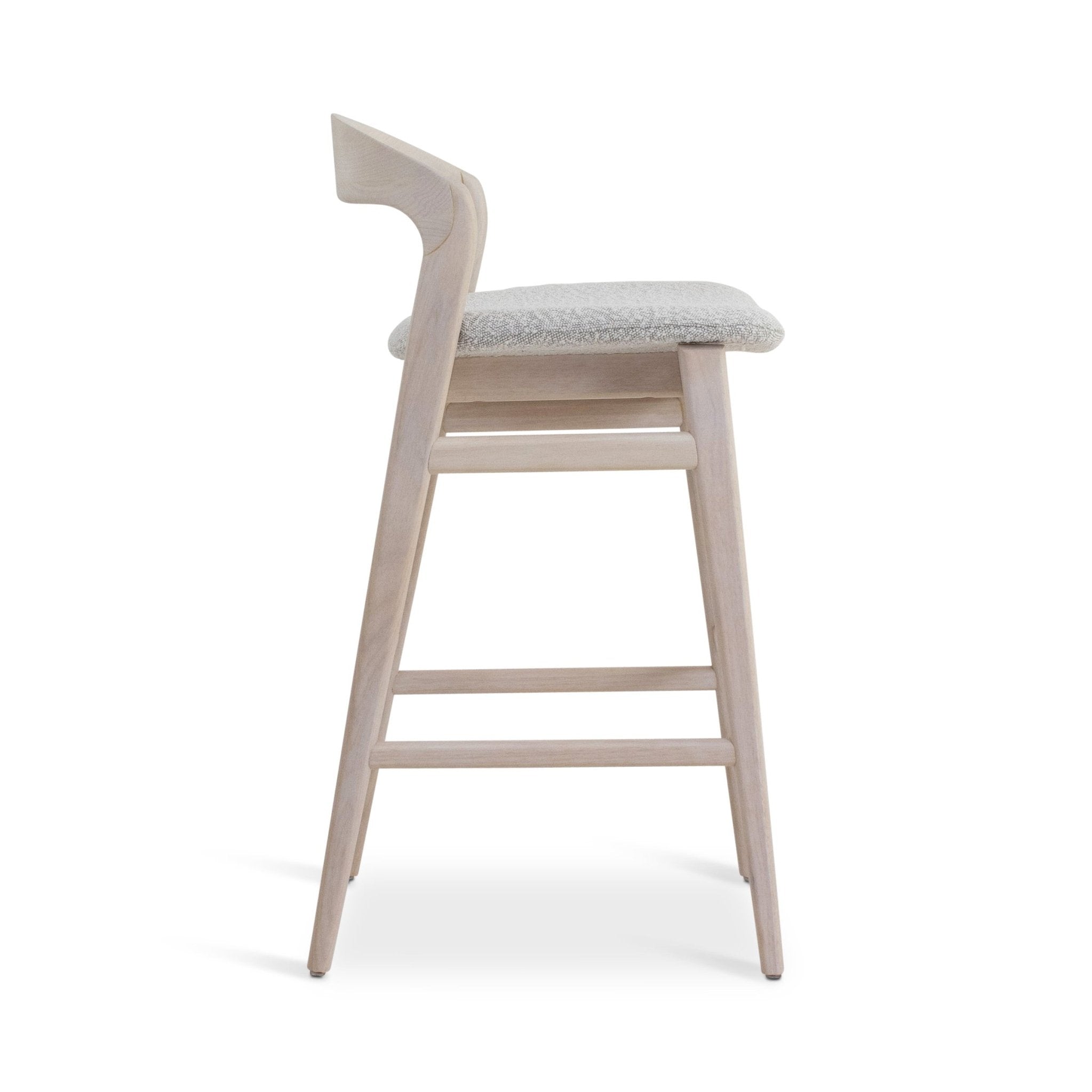 Side angled view of a dark wood bar stool with white cushioned seat.