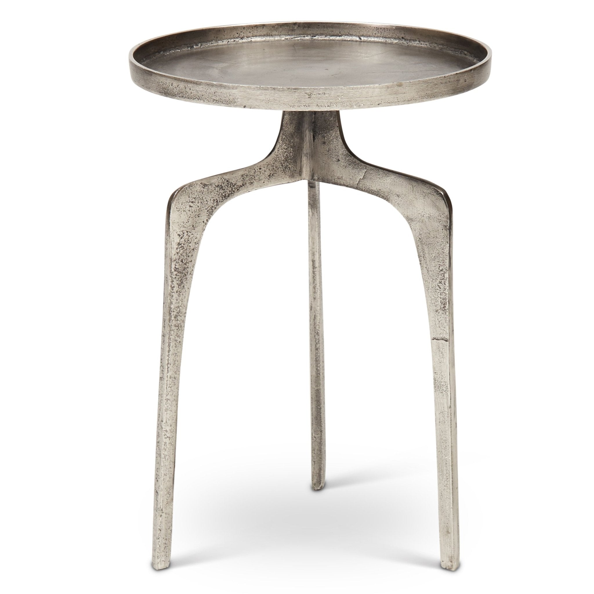 Close-up of metal tabletop showing circular edge and worn texture.