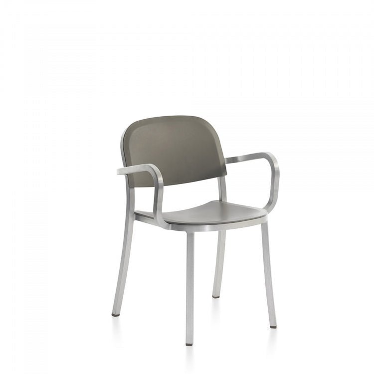 Blue-green upholstered armchair with metal frame and curved arms.
