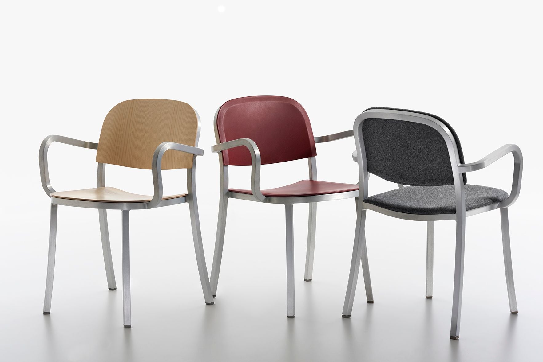Set of mixed-color dining chairs with metal frames and colored seat and back panels.