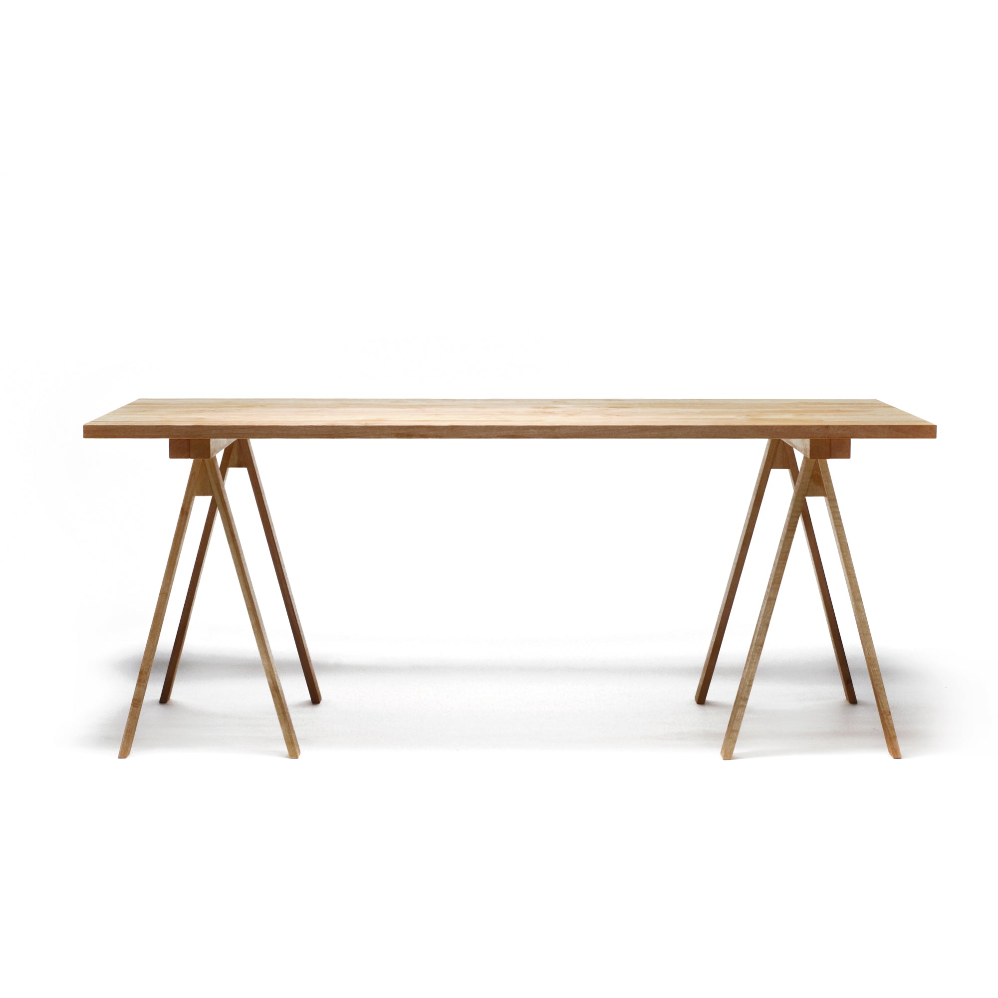 A long wooden table with four tapered legs