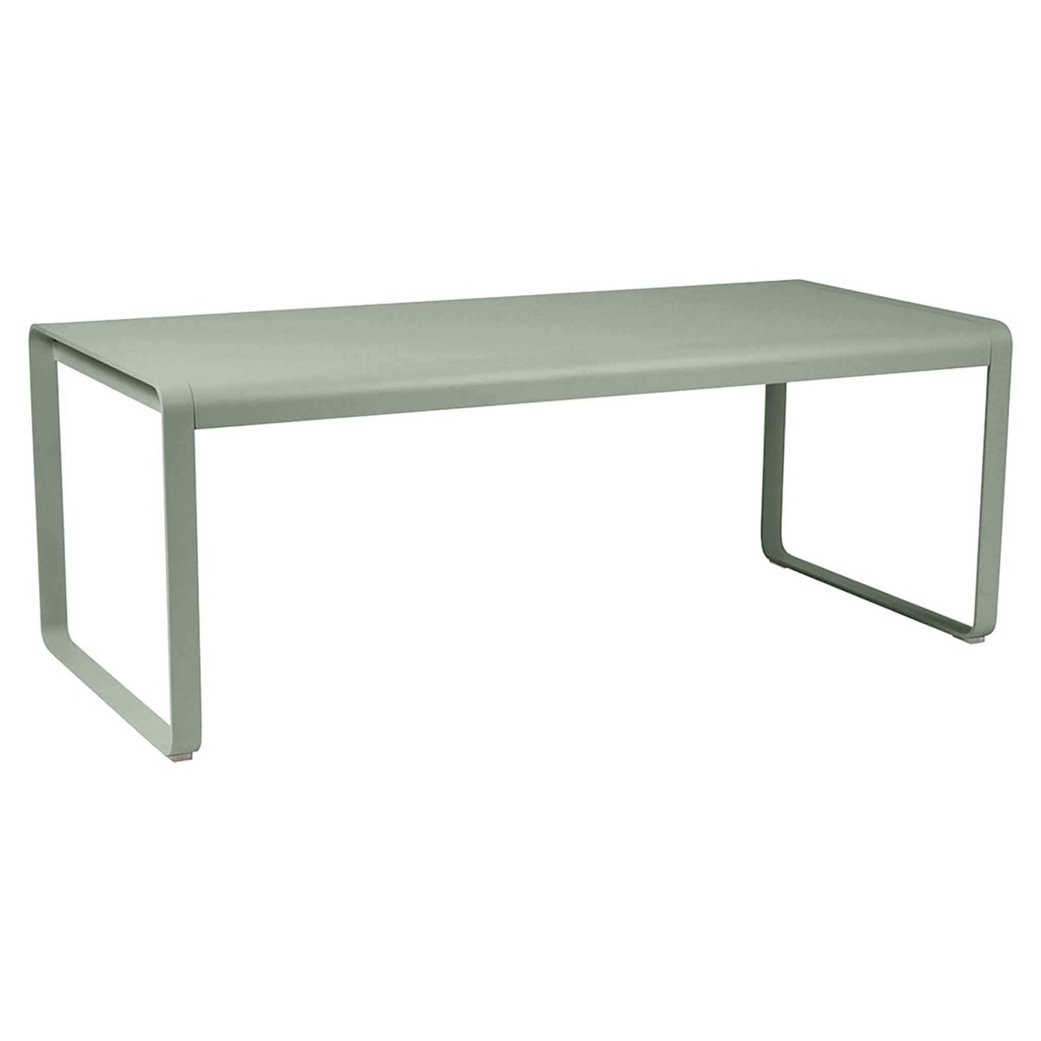 a muted green bench with a smooth surface and four legs