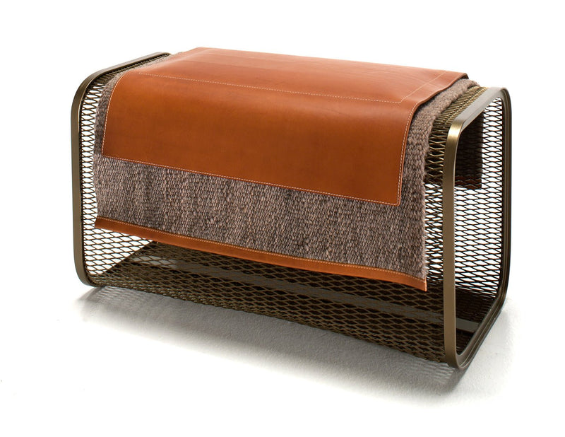 Close-up of the tan leather flap and textured panel of the same clutch showing stitching and material detail