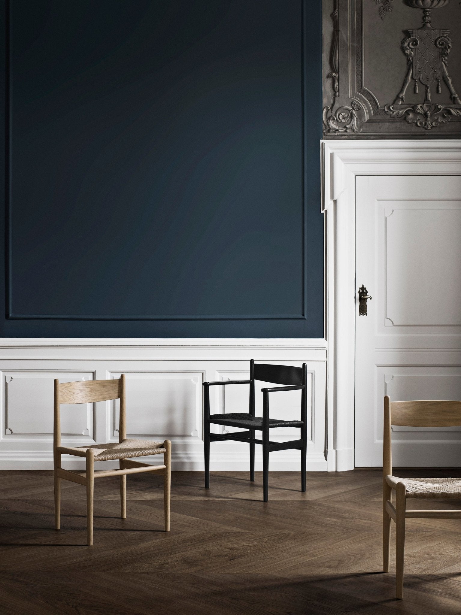 Black wooden chair with woven seat, front view