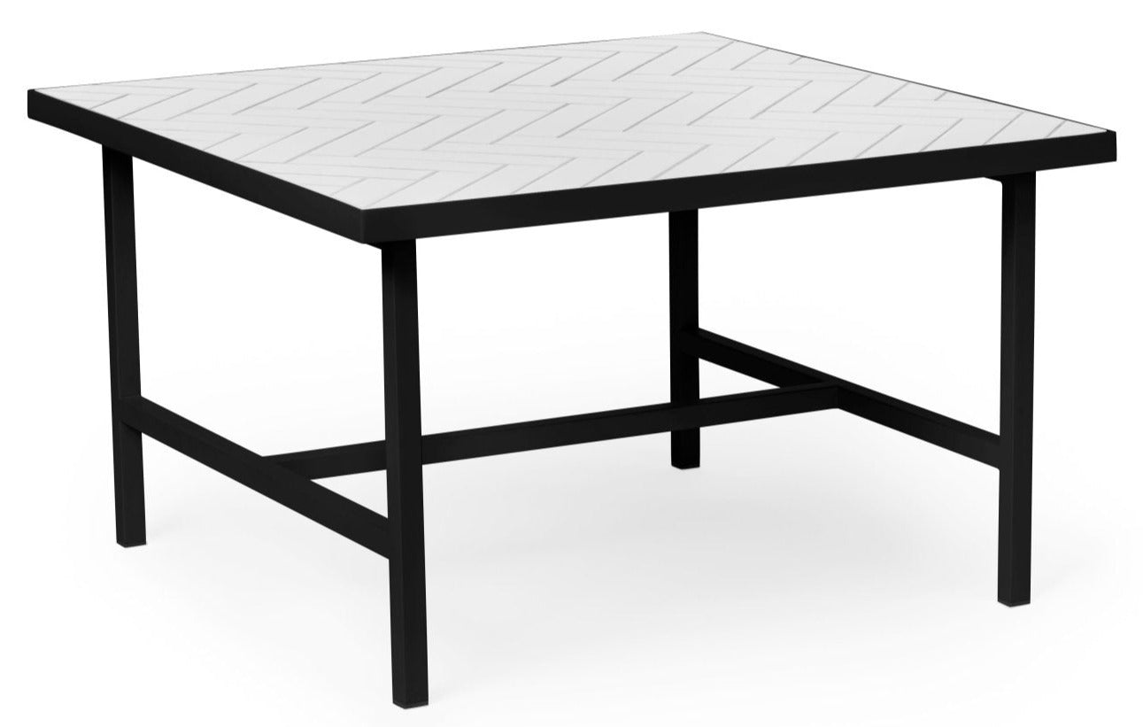 A black table with a white tile top in a herringbone pattern