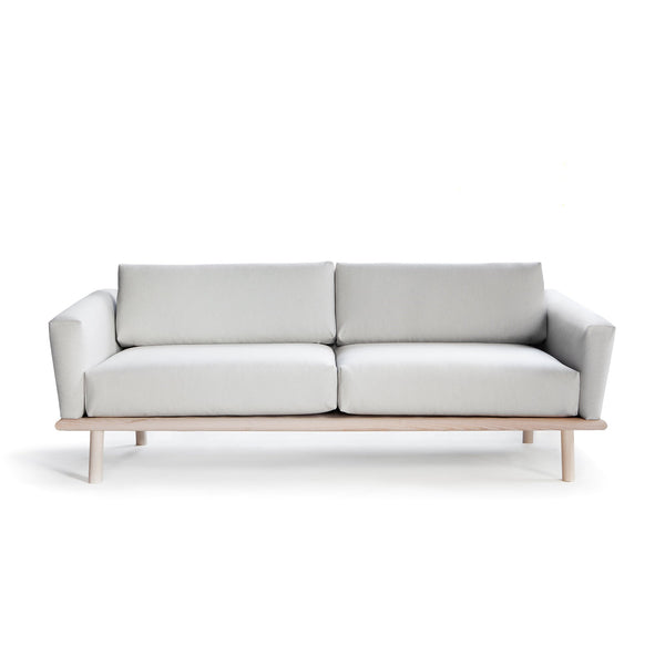 Linea Sofa by Nikari. A modern grey living room couch with a wood frame.
