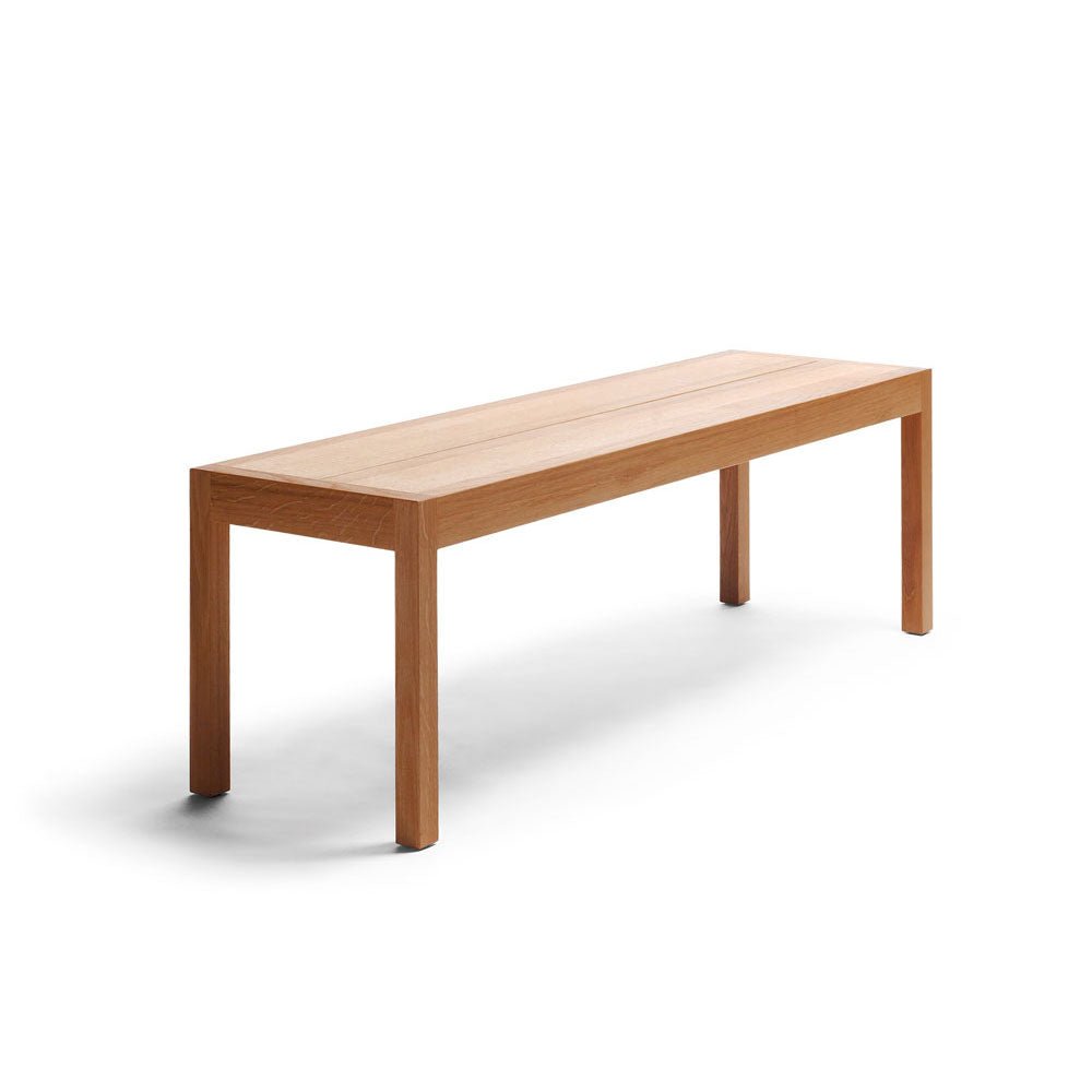 A wooden bench with four legs